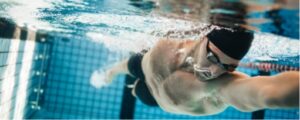 underwater shot of man swimming