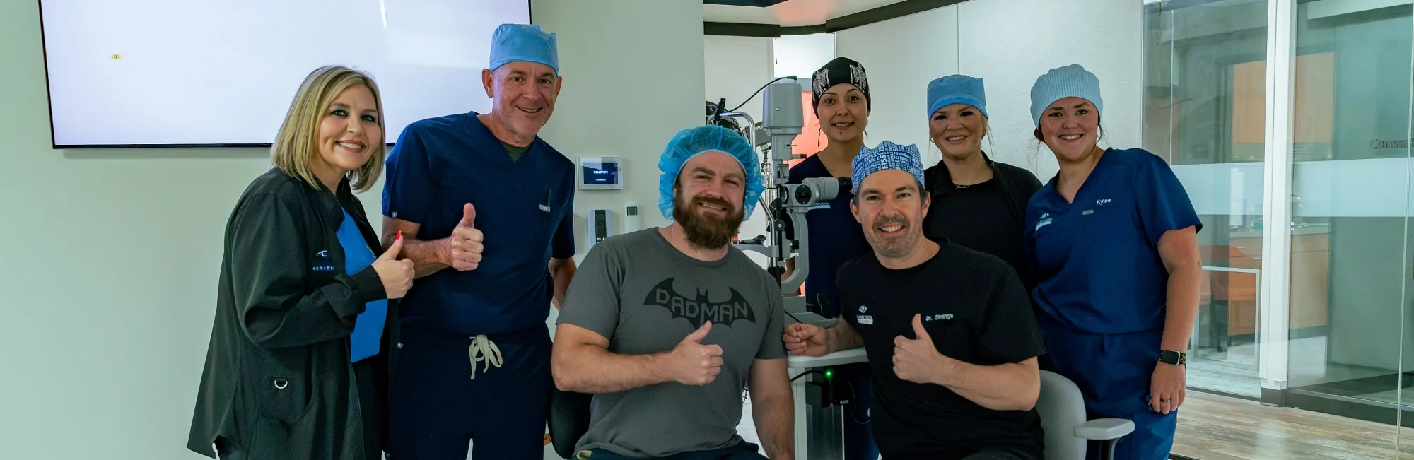 Navy SEAL veteran Briggs giving a thumbs up with Dr. Taylor Strange and the Alliance Vision Institute team after LASIK